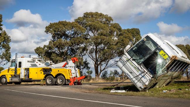 The bus is hoisted upright at the crash site. Picture: Jake Nowakowski