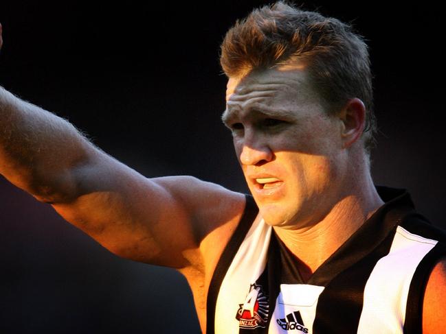 Collingwood v Essendon. MCG. Anzac Day match. Nathan Buckley shields the late afternoon sun from his eyes.