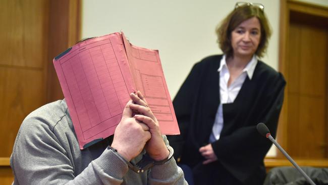 Prolific killer: German former male nurse Niels Hoegel hides his face in court. Picture: AFP