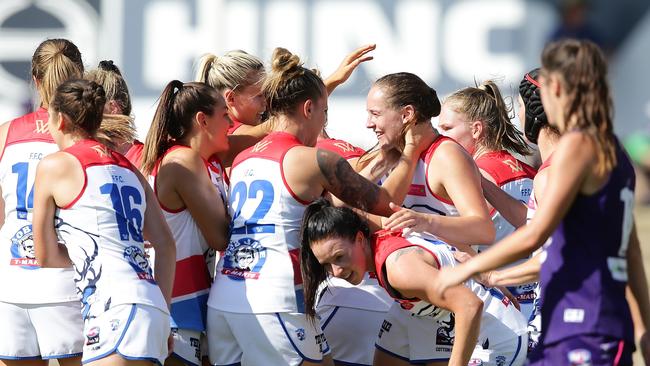 Isabel Huntington is mobbed by teammates after kicking a goal. Picture: Getty Images