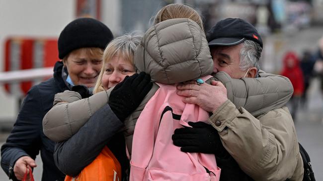 A family reunites just after crossing the Ukrainian border into Poland.