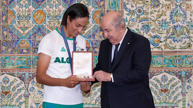 President Abdelmadjid Tebboune presents an award to Imane Khelif in the Algierian capital after the Olympics. (Photo by ALGERIAN PRESIDENCY FACEBOOK PAGE / AFP)