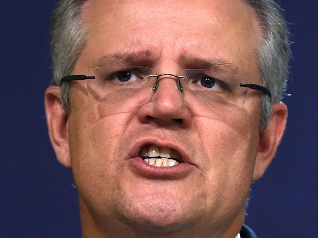 (FILES) This file photo taken on August 4, 2016 shows Australia's Treasurer Scott Morrison speaks during a press conference in Sydney.  A US hedge fund plan for mining giant BHP Billiton to move its primary listing to London was shot down by the Australian government on May 4, 2017 which warned of criminal charges if it went ahead. Treasurer Scott Morrison said removing BHP from the Australian Stock Exchange was not in the national interest. Under conditions imposed by then-treasurer Peter Costello in 2001 when BHP merged with the British miner Billiton, its assets must be held by a company listed in Australia. / AFP PHOTO / Saeed KHAN