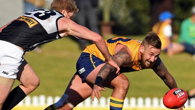 The Eagles’ Lewis Scott attempts to gather the ball under pressure from Port's Matthew Lobbe. Picture: Tom Huntley