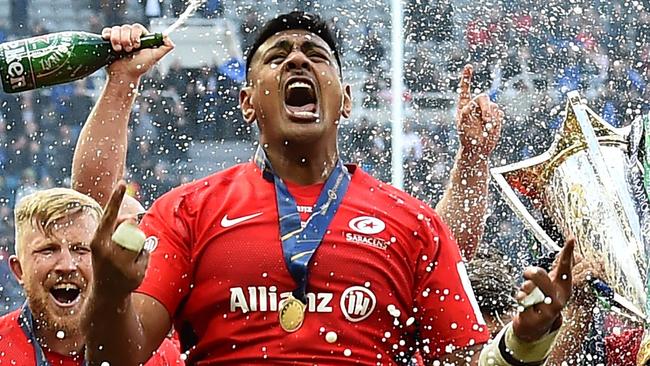 TOPSHOT - The champagne is sprayed as Saracens' players including Saracens' New Zealand born Australian lock Will Skelton (C) celebrate their win on the field after the European Rugby Champions Cup final match between Leinster and Saracens at St James Park stadium in Newcastle-upon-Tyne, north east England on May 11, 2019. - Saracens won a third European Champions Cup title in four years with a 20-10 win over Leinster on Saturday. (Photo by Glyn KIRK / AFP)