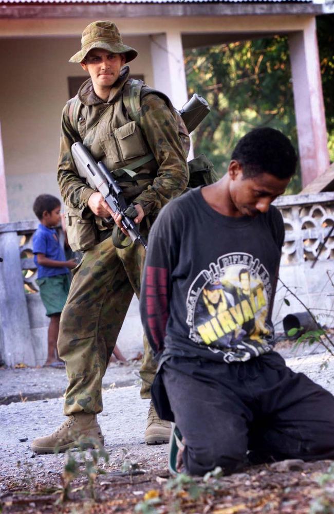 Risky ... an Australian soldier detains a suspected militia member in East Timor, 1999.