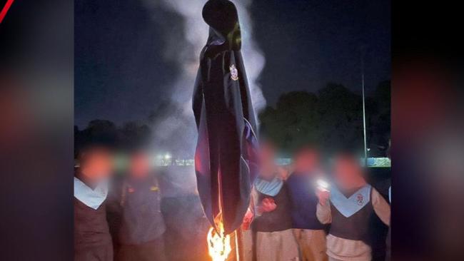 Students posed for pictures as a rival college's sports jacket was set on fire. One student has been expelled with their parents claiming he’s been a ‘scapegoat’. Picture: 7NEWS