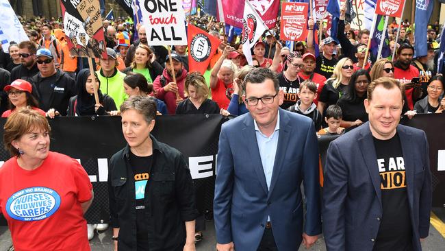 Premier Daniel Andrews (second right) speaks with union leaders before a rally through the streets of Melbourne on October 23. Picture: AFP