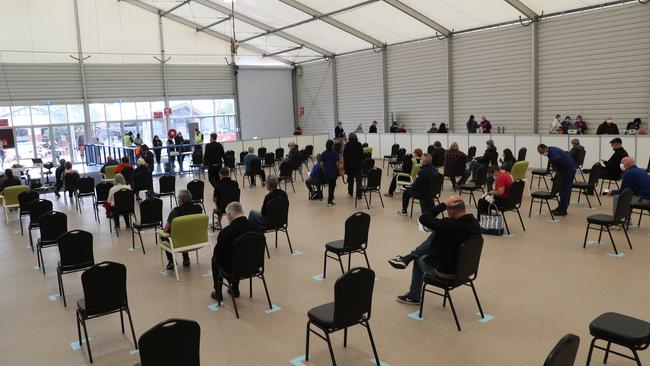 People in the recovery area inside the COVID-19 Vaccine centre at Melbourne Showgrounds. Picture: NCA NewsWire / David Crosling