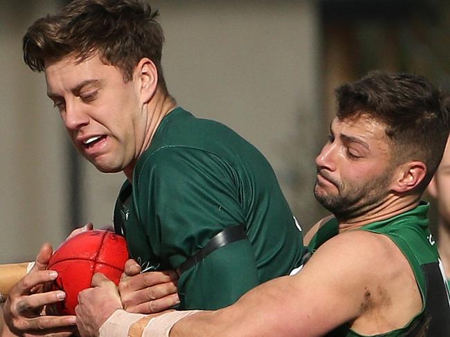 Tyson Young of Airport West is tackled by Christopher Farchione of Greenvale during EDFL footy: Airport West v Greenvale on Saturday, August 10, 2019, in Reservoir, Victoria, Australia. Picture: Hamish Blair