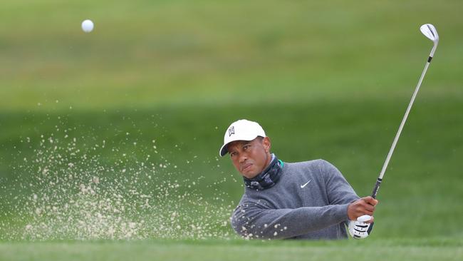 Tiger Woods plays out of a bunker during a practice round for the PGA Championship