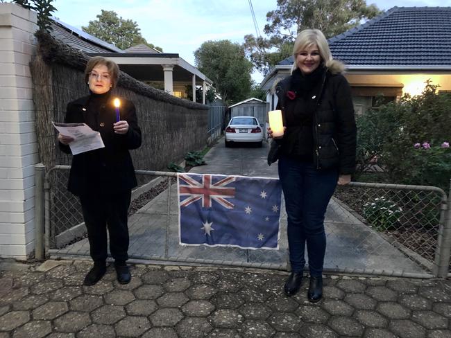 Caption: Lifelong friends Barbara Heidrich and Wendy Arbon pay their respects at first light on Beatty Street, Linden Park - home of the Royal Australian Rgiment Association SA (Burnside) RSL Sub Branch. Their fathers both served their country. Ms Arbon's father Robert Jewell Chapman saw action in Borneo during WWII, while her grandfather Frederick Chapman served in World War I. Ms Heidrich's father Alfred Heidrich was stationed in Darwin and Magnetic Island. Picture: Jackie Tracy