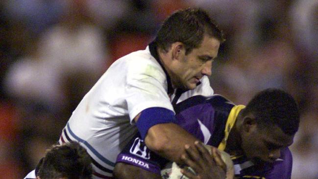 Storm winger Marcus Bai is wrapped up by Penrith forwards Mark Geyer (top) and Nigel Gaffey.