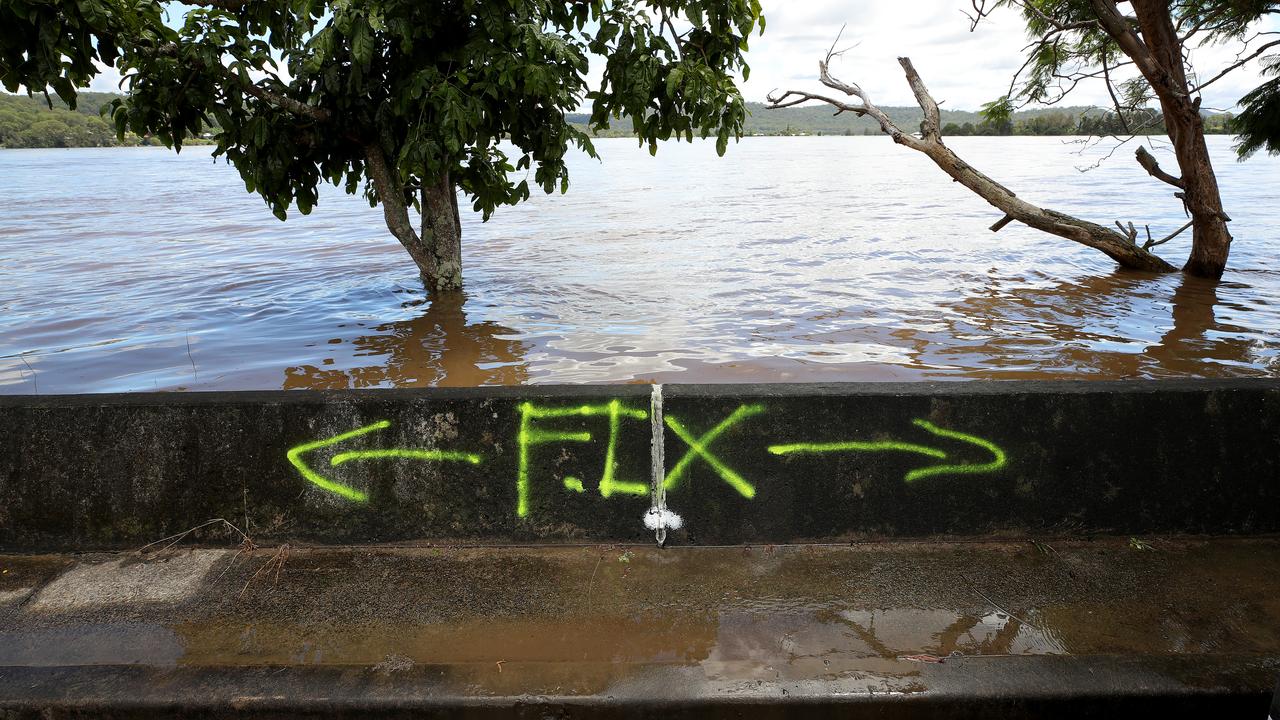 The levee wall along the Clarence River at Maclean has managed to keep most of the flood waters out of the town, although some areas are being repaired. Picture: Toby Zerna