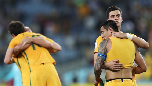 Tomi Juric and Tim Cahill of Australia