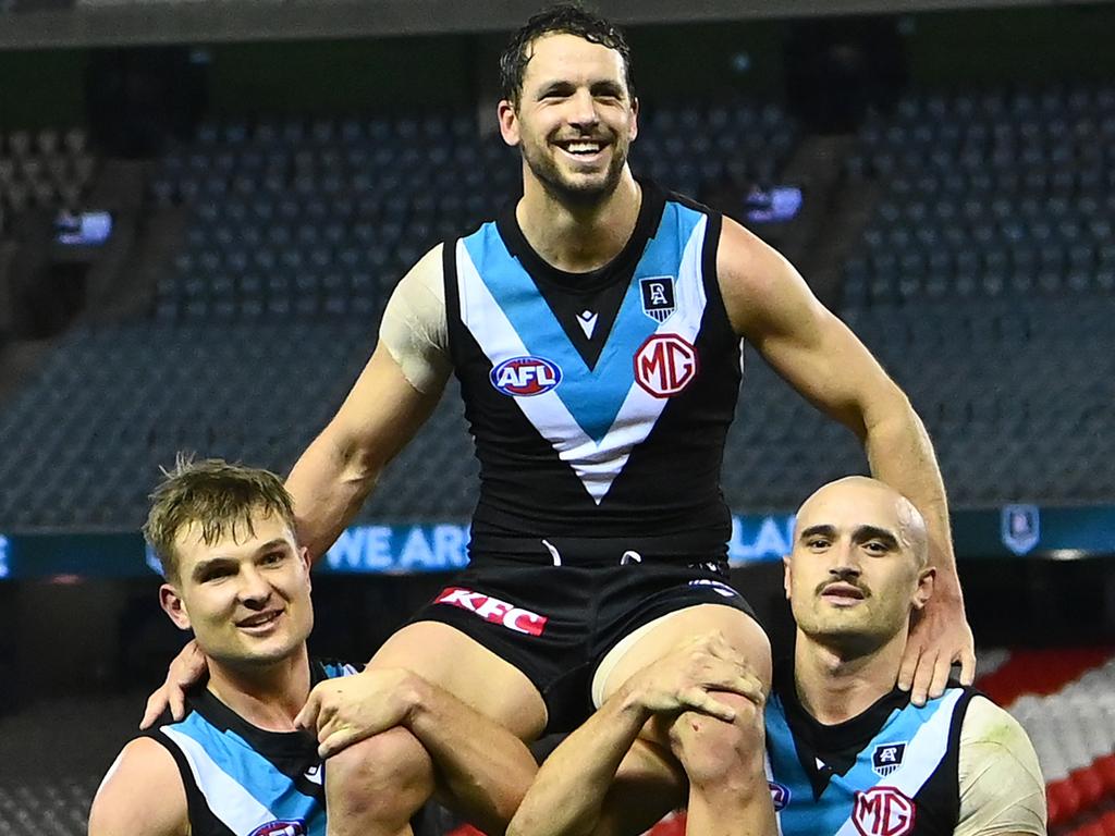 Travis Boak being chaired off at an empty stadium after game 300.Picture: Getty Images