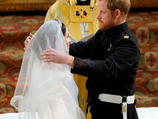 Prince Harry lifts Meghan’s veil from her face. Picture: Owen Humphreys