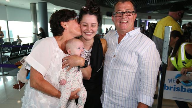 Christine and Michael Preece with daughter Stephanie and new granddaughter Charlotte, who arrived on the first Melbourne flight into Brisbane. Picture: Getty Images