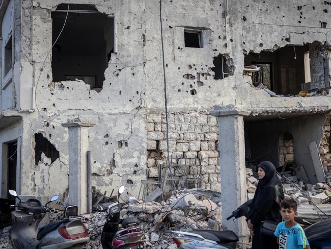 Survivors stand in front of an apartment block destroyed in a recent Israeli strike in Mays Al-Jabal, Lebanon. Picture: Getty