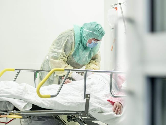 A nurse in protective clothes takes a blood sample of a patient potentially infected by the novel coronavirus Covid-19 at the Turku University Hospital Tyks in Turku, Finland, on April 3, 2020. (Photo by Roni Lehti / Lehtikuva / AFP) / Finland OUT