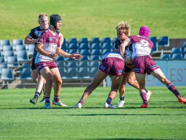 Wiliam Craig is hit hard by the Manly defence. Picture: Thomas Lisson