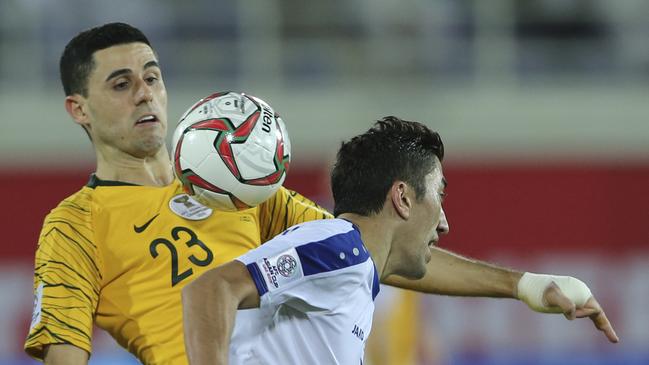 Socceroos midfielder Tomas Rogic, left, controls the ball against Uzbekistan's midfielder Odil Ahmedov. Picture: AP