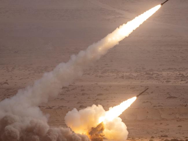 A US M142 High Mobility Artillery Rocket System (HIMARS) fires salvoes during the second annual 