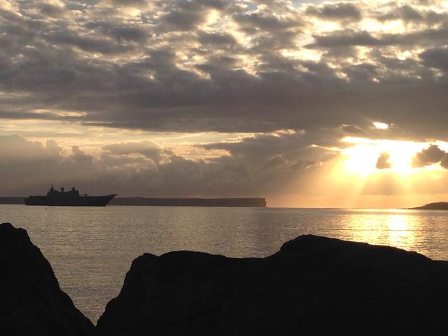 Sunrise ... HMAS Canberra being put through its paces in Jervis Bay, NSW. Picture: Paul Newman