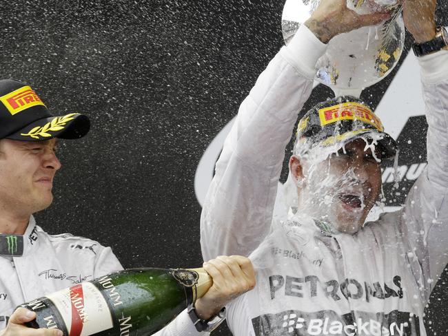 Nice Rosberg sprays champagne all over winner and Mercedes teammate Lewis Hamilton.