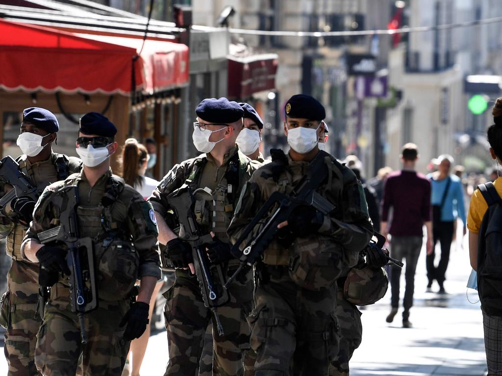 French soldiers wear protective face masks as they patrol the Champs Elysees Avenue in Paris. Picture: AFP
