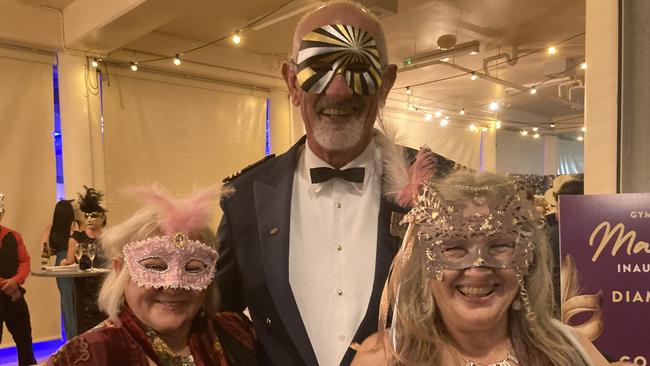 Linda McHenry, John Herlihy and Jenni Dunn celebrate at the Gympie RSL Masked Ball, April 29 2023.