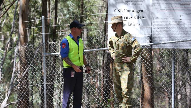 Australian defence personal and MSS security crew guard the entrance of Killarney Glen waterhole where a man is reported to be missing at Killarney Glen waterhole, Gold Coast. Photo: Regi Varghese