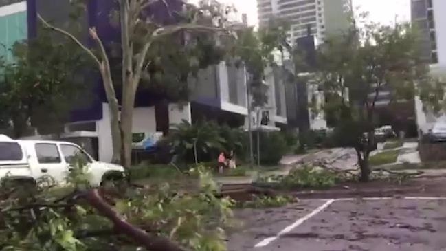 People lend a hand to clear trees from McMinn St in Darwin