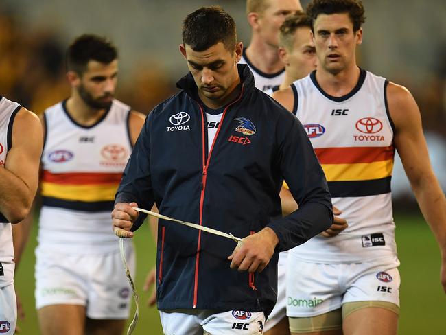 Taylor Walker of the Crows leads his players from the ground after the Round 13 AFL match between the Hawthorn Hawks and the Adelaide Crows at the MCG in Melbourne, Saturday, June 16, 2018. (AAP Image/Julian Smith) NO ARCHIVING, EDITORIAL USE ONLY