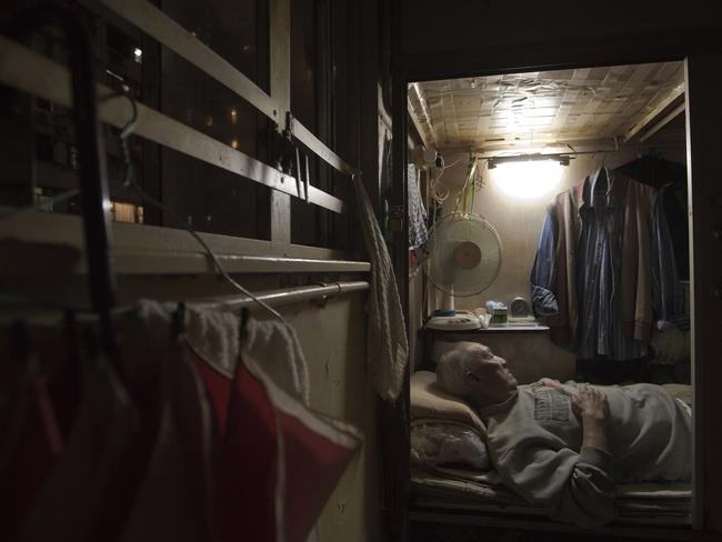 Tse Chu, a retired waiter, is seen sleeping in his cramped home. Picture: Kin Cheung/AP