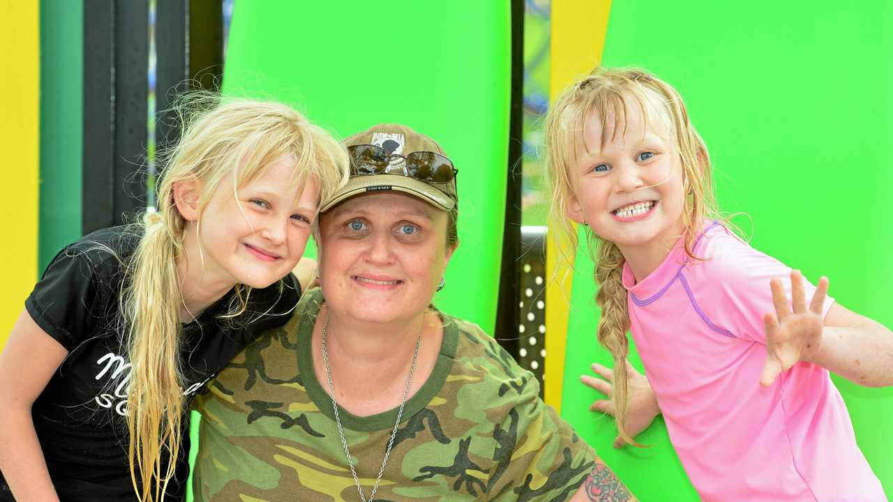 Salty Souls Legacy at Kings Beach, helping vulnerable children with a surfboard of their own. Katherine and Kimberlie with their mother Kerstin. Picture: John McCutcheon