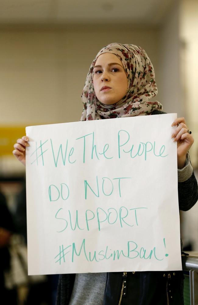 April Harrison-Bader protests President Donald Trump's executive action barring individuals from certain Muslim majority countries from entering the United States at Terminal D at Dallas Fort Worth Airport. Picture: AP