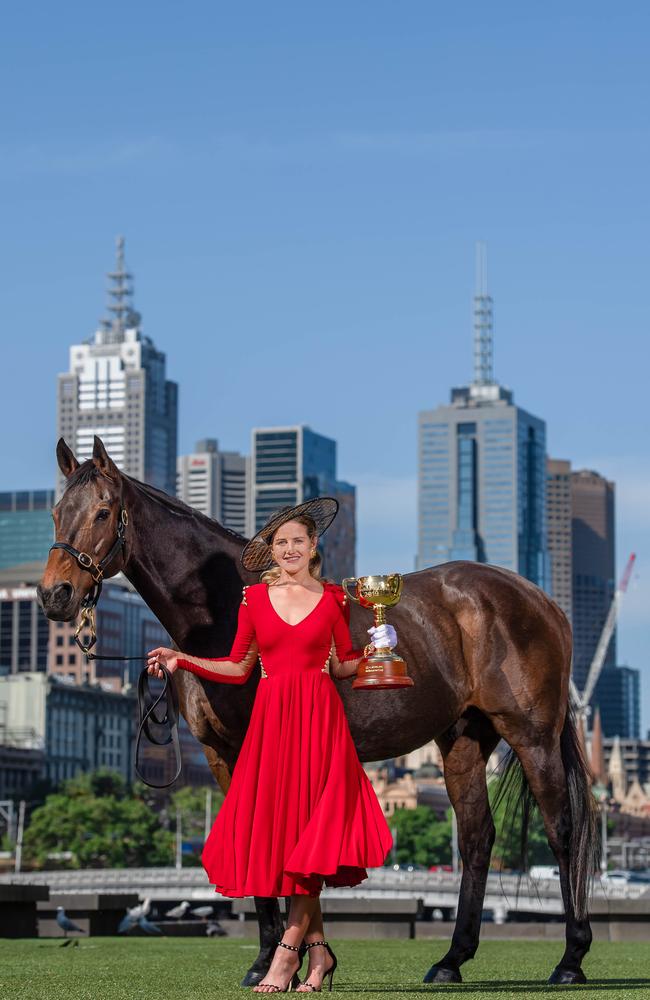 Payne with this year’s Melbourne Cup trophy and 1997 winner Might And Power.