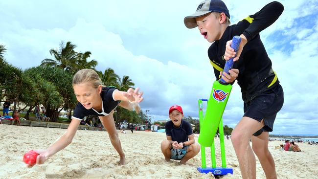 Molly Stoddart, 11, Joe Stoddart, 9 and Hugh Rylance, 9 of Brisbane get stuck into some beach cricket on Main Beach, Noosa Heads.