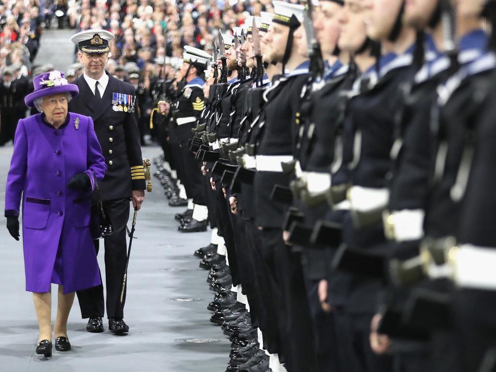 Queen Elizabeth II inspects the Royal Guard with the ship's commanding officer, Commodore Jerry Kyd as she attends the Commissioning Ceremony in Portsmouth, southern England on December 7, 2017. Picture: AFP