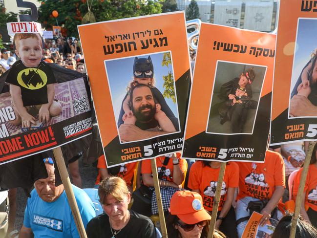 Protesters lift placards and pictures during a gathering in Tel Aviv to mark the fifth birthday of Ariel Bibas, held hostage in Gaza, and to call for the liberation of him and his family. Picture: AFP