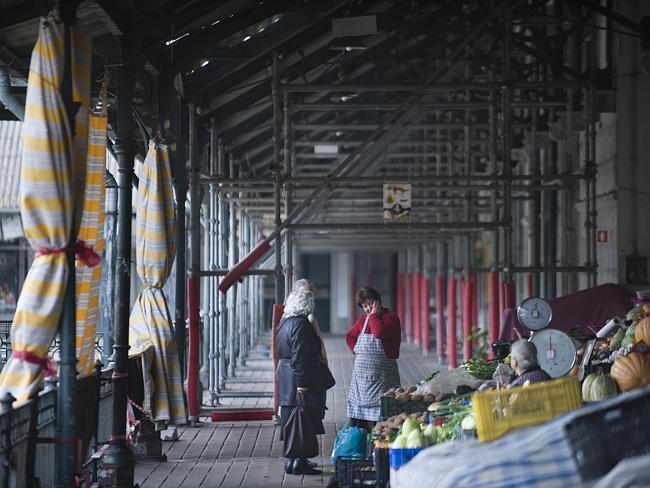 A seller talks with customers at the traditional Bolhao market in central Porto. Picture: AFP