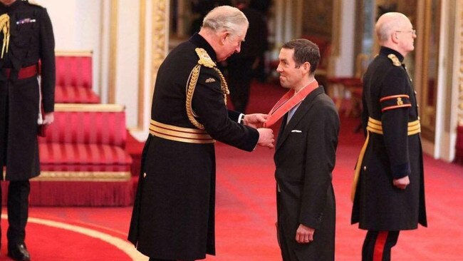 Lex Greensill receives his award as Commander of the British Empire from Prince Charles in 2017.