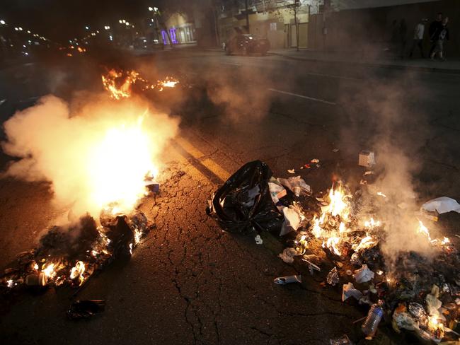 Multiple fires are lit in dumpsters and rubbish bins in Oakland. Picture: Jane Tyska/Bay Area News Group via AP