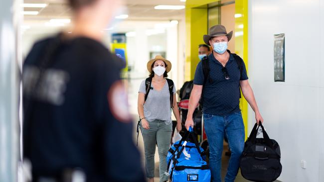 Qantas flight QF838 passengers head out of the airport and onto buses bound for Howard Springs quarantine facility. Picture: Che Chorley