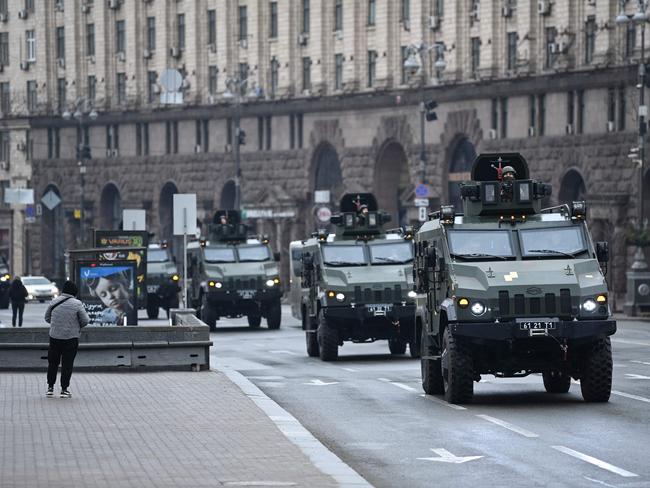 Ukrainian military vehicles move past Independence Square in central Kyiv as Russia invades. Picture: AFP