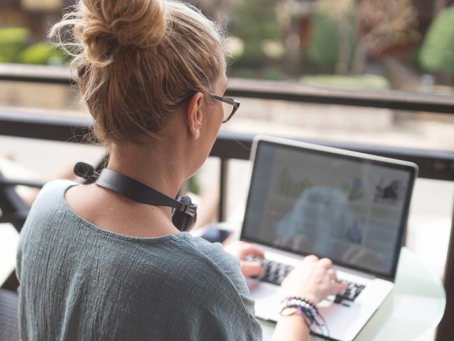 Businesswoman sitting alone and typing on her laptop working during her vacation. Picture: iStock