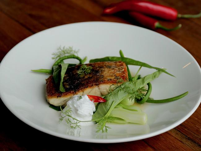 The barramundi fillet with lemongrass broth and Asian greens. Picture: Jenifer Jagielski