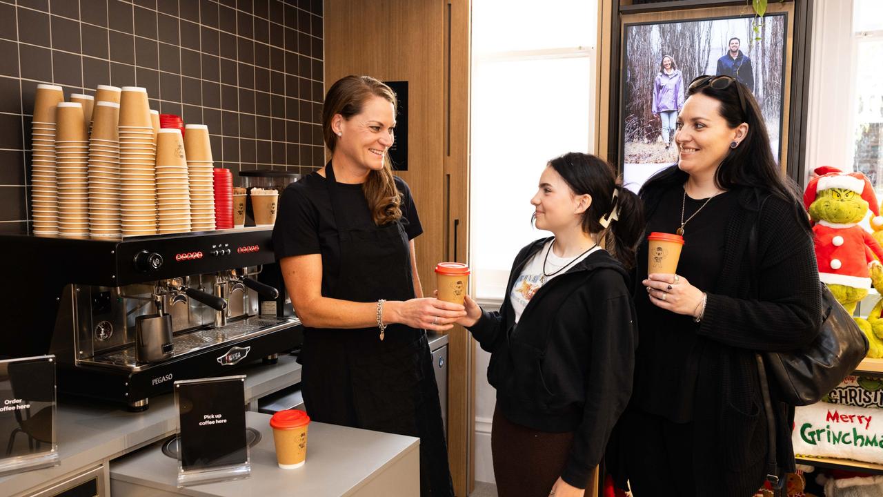 An Australia Post barista making coffee for mother and daughter Vicky and Laura Baressi (12) at Australia Post's newly refurbished and designed community hub post office in Orange, NSW. Picture: Supplied