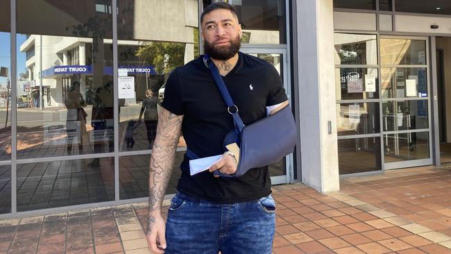 John Lavulo wearing a sling outside Campbelltown Court.